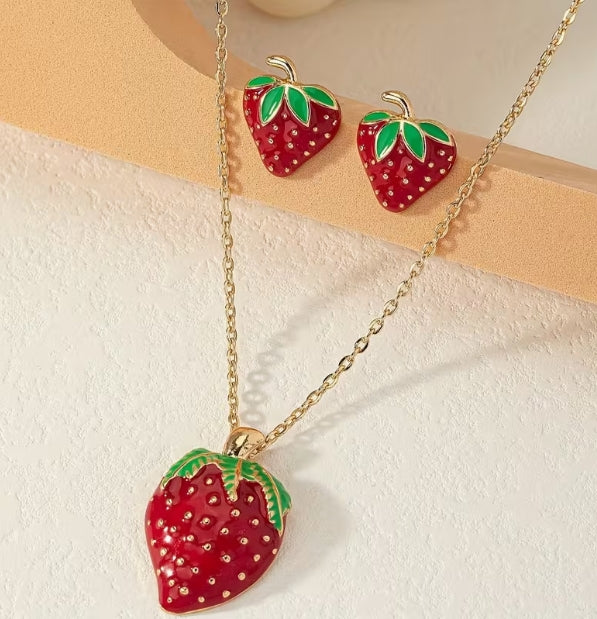 Strawberry necklace and earrings set flat lay